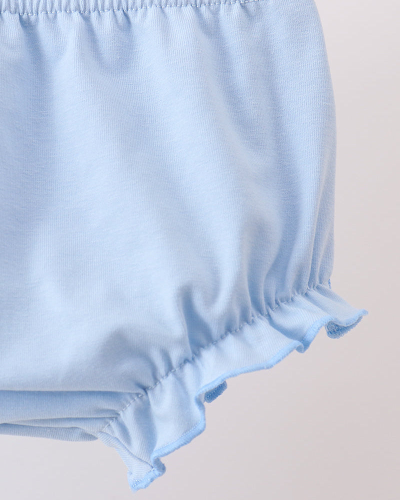 Light blue baby bloomers on a beige background