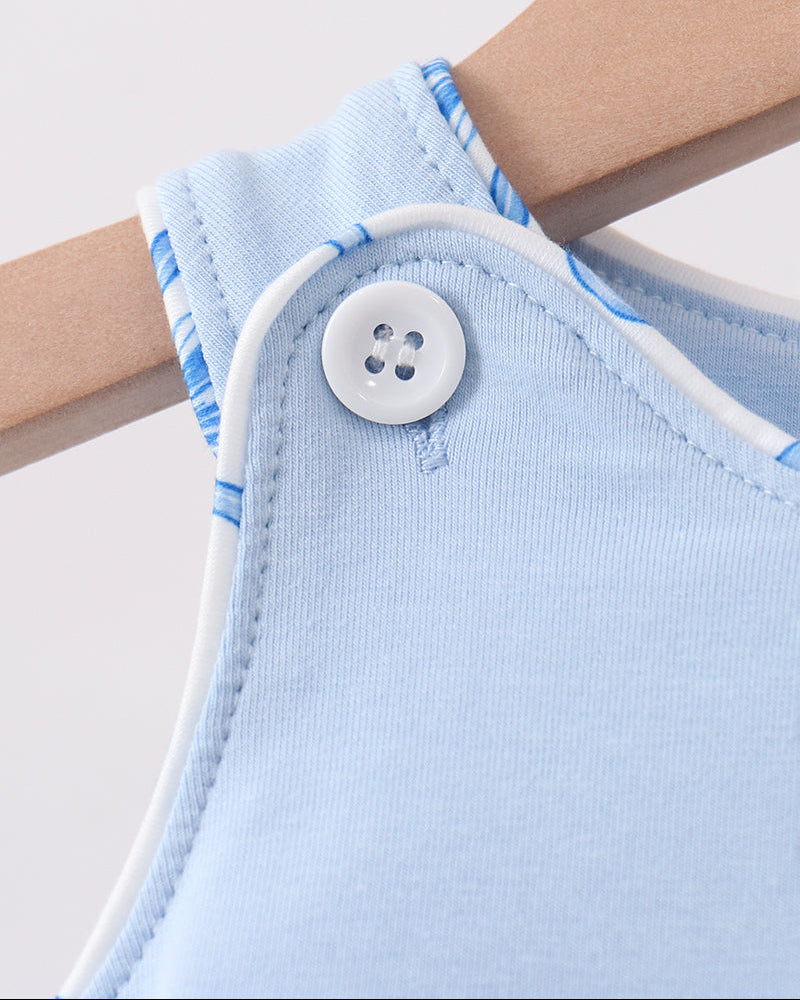 Light blue baby romper with a white button on a hanger against a light background