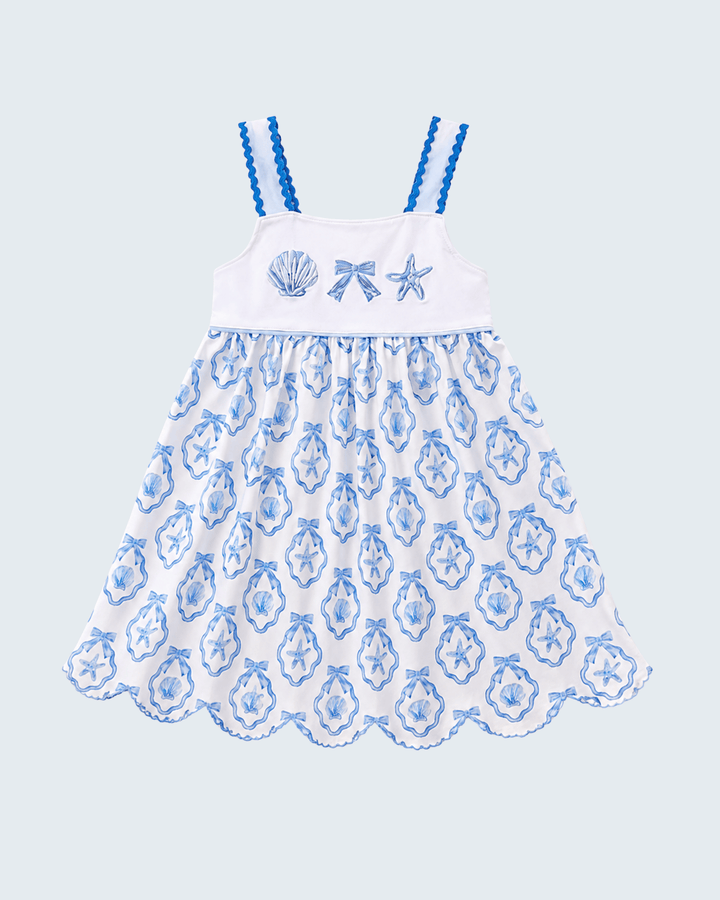 White dress with blue floral pattern and starfish design on a light blue background