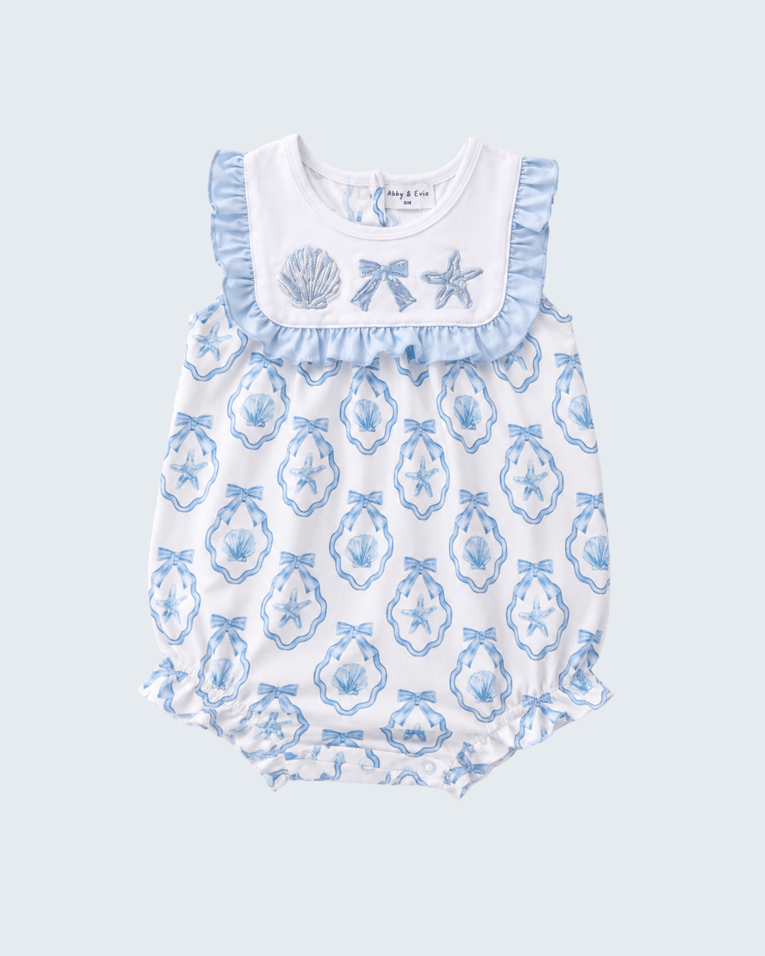 Baby romper with blue shell pattern on a light blue background