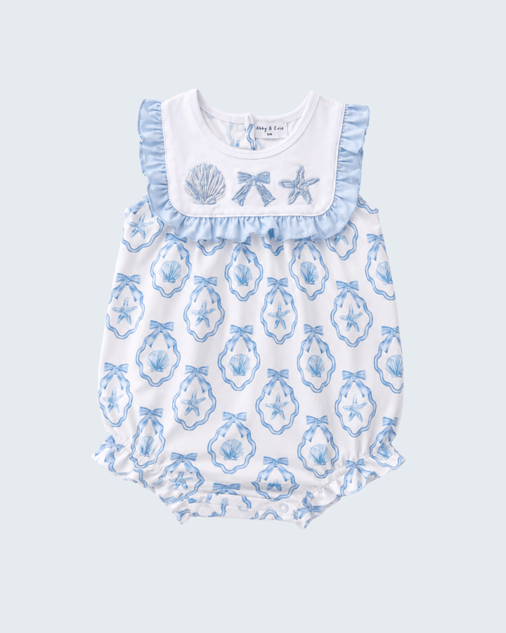 Baby romper with blue shell pattern on a light blue background