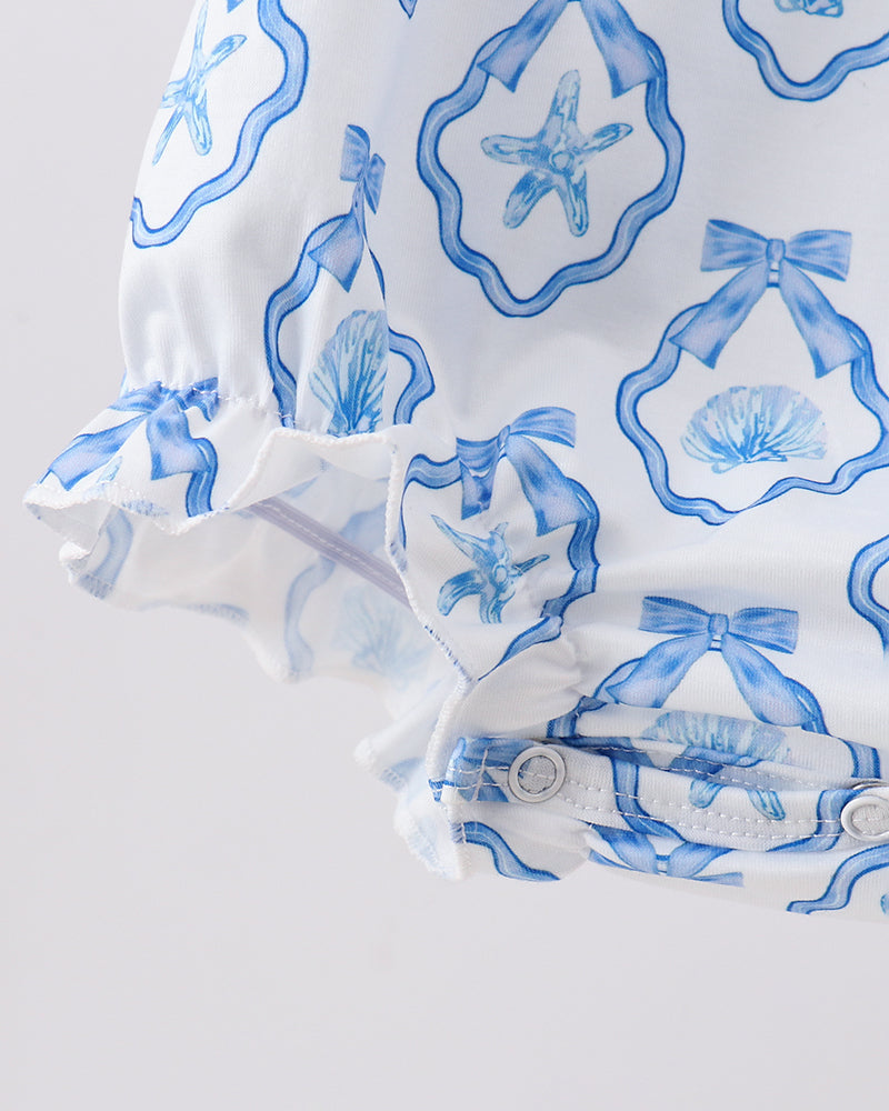 Baby outfit with blue starfish and shell pattern on a light gray background