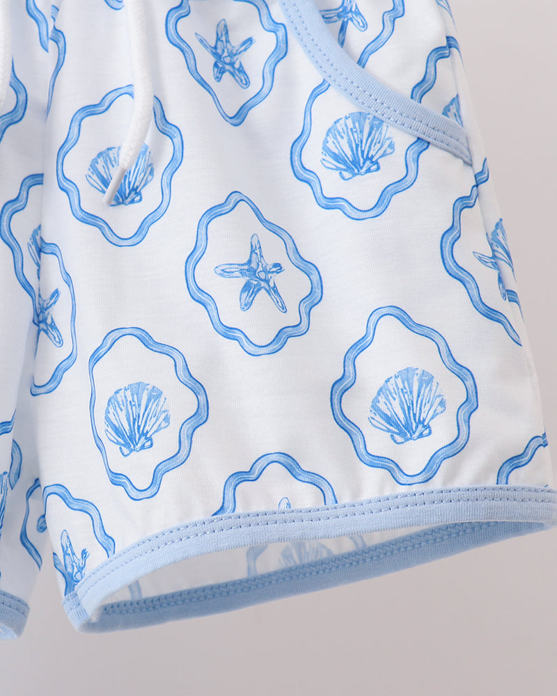 Shorts with blue shell pattern on a light gray background