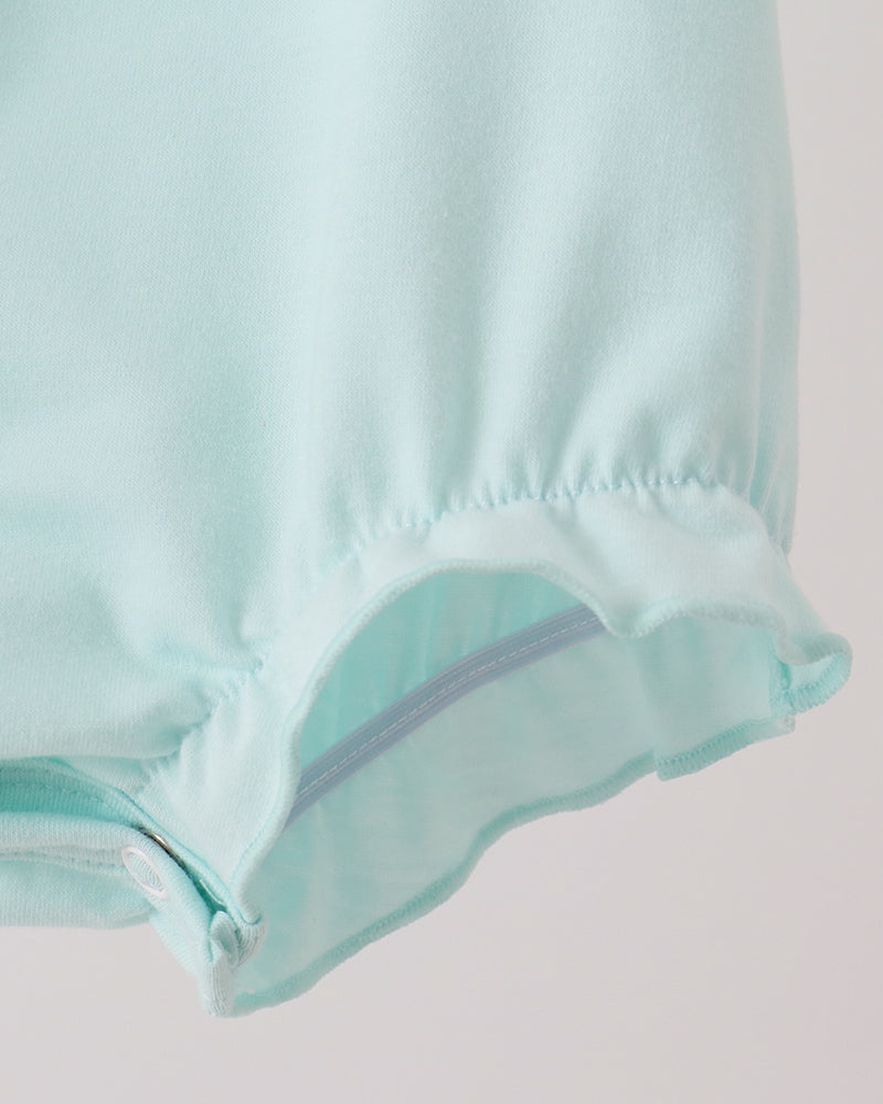 Mint green romper leg hem with gathered ruffle and seam detail
