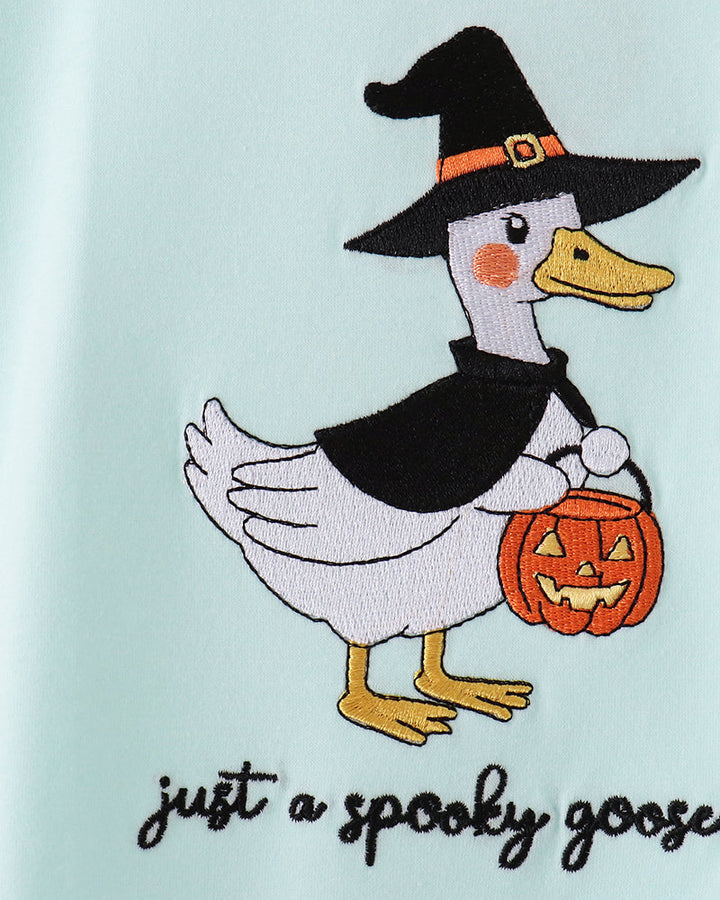 Light blue romper with close-up of embroidered black-hat goose holding orange jack-o-lantern