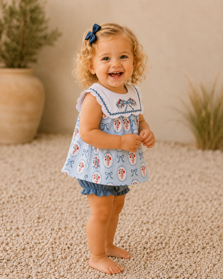 Toddler girl standing outside. Neutral background.