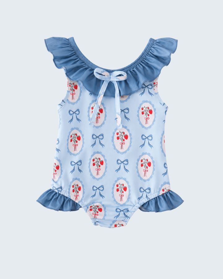 Swimsuit with floral and bow pattern on a light blue background