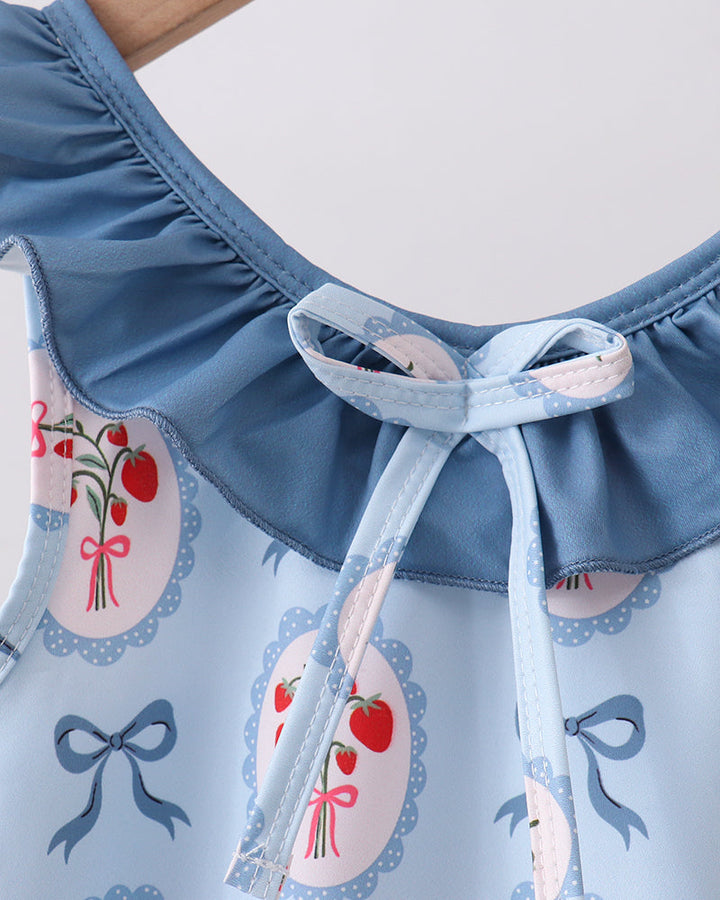 Swimsuit with floral and bow pattern on a light blue background