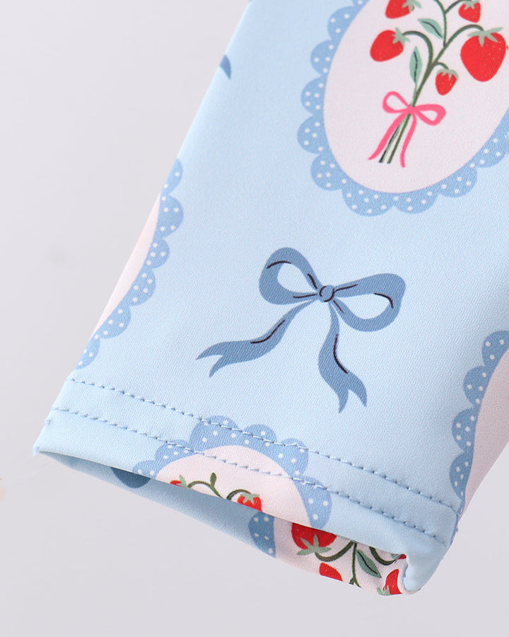 Light blue fabric with floral and bow design on a white background
