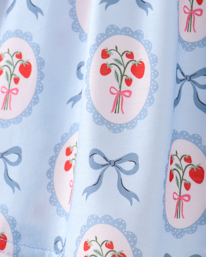 Fabric with cherry and bow pattern on a light blue background