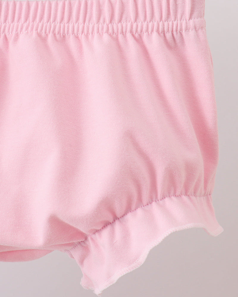 Pink baby bloomers on a light gray background