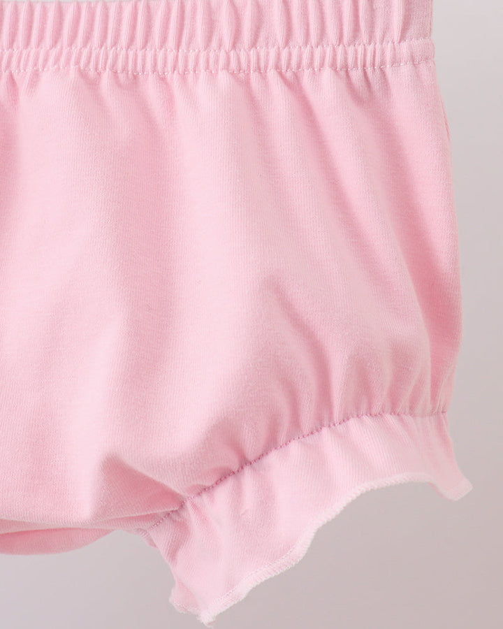 Pink baby bloomers on a light gray background