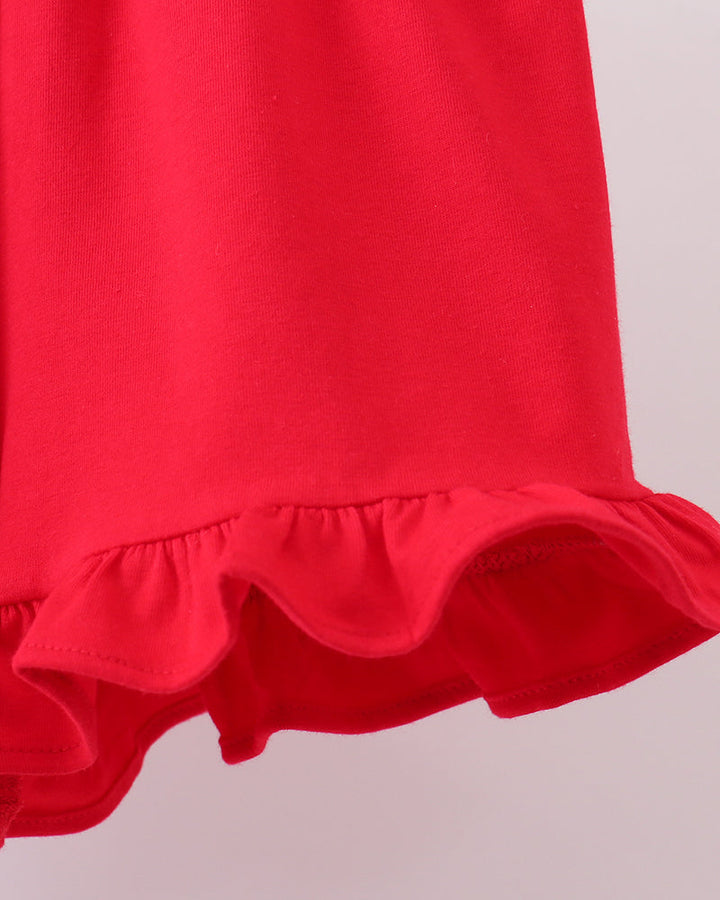 Red shorts with ruffled hem on a light gray background