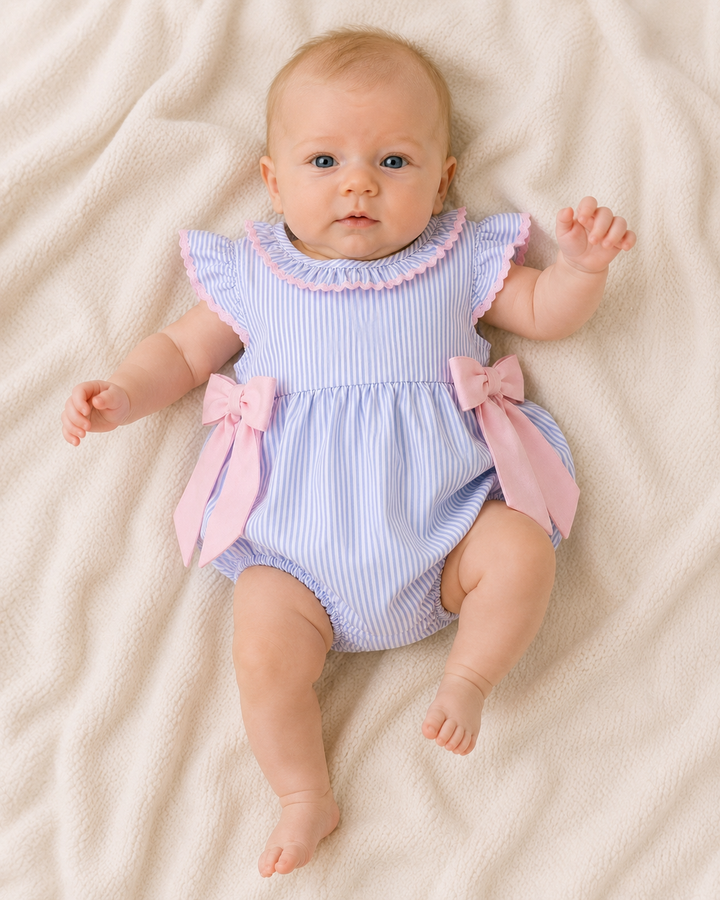 Infant girl laying on a soft blanket