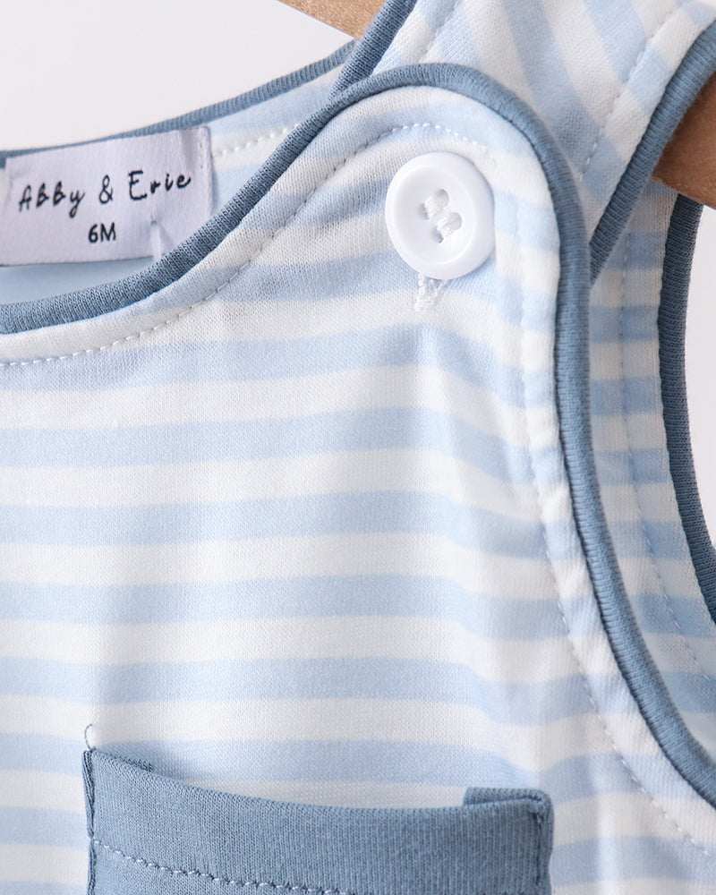 Close-up of a baby romper with blue and white stripes, a button, and a pocket.