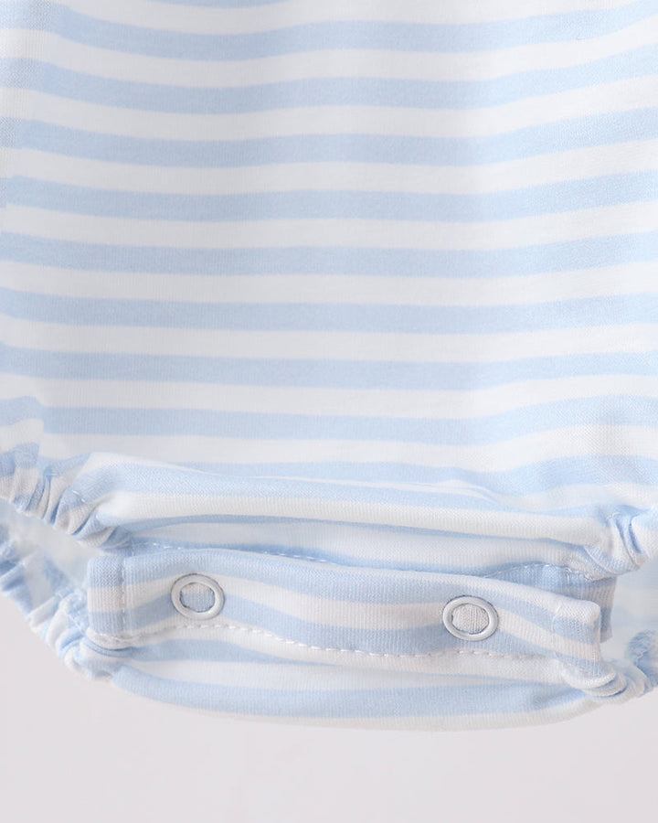 Close-up of a blue and white striped baby outfit on a light gray background