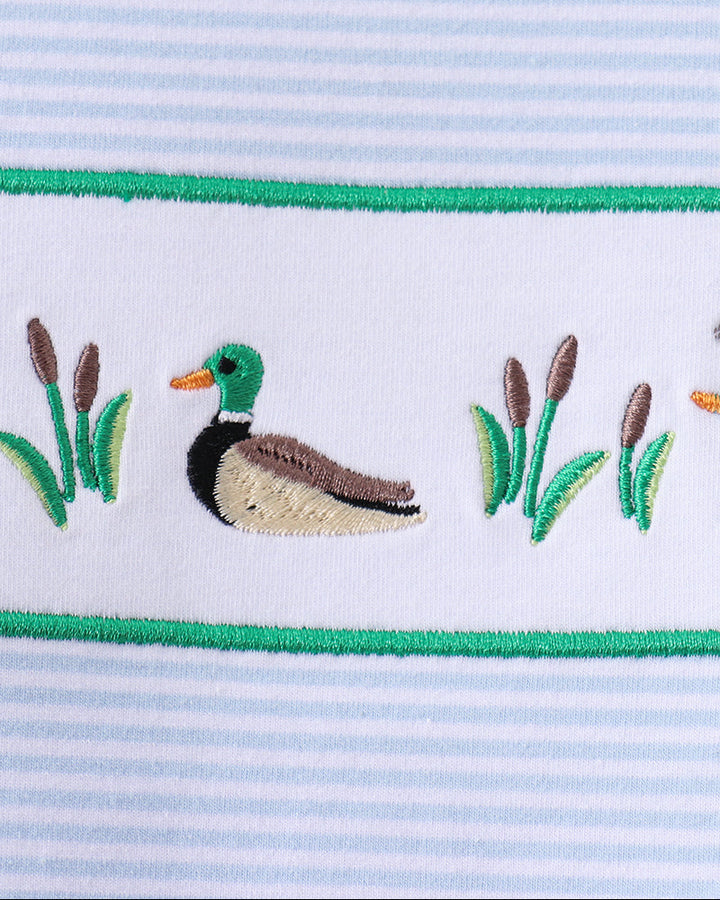Embroidered duck and reeds patch on light blue striped shirt