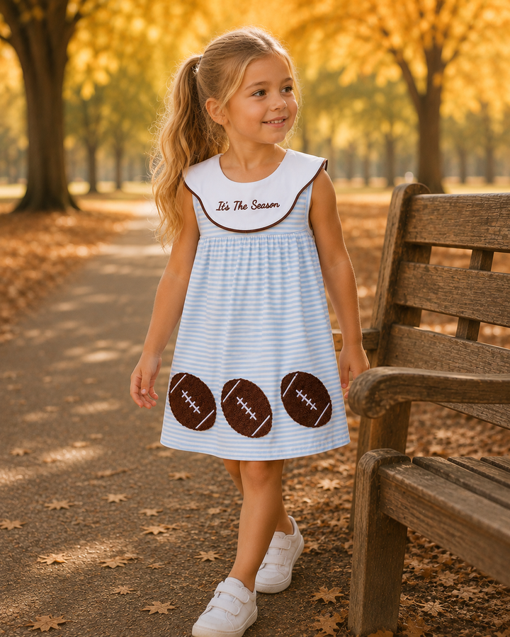 A young girls wearing a football dress.