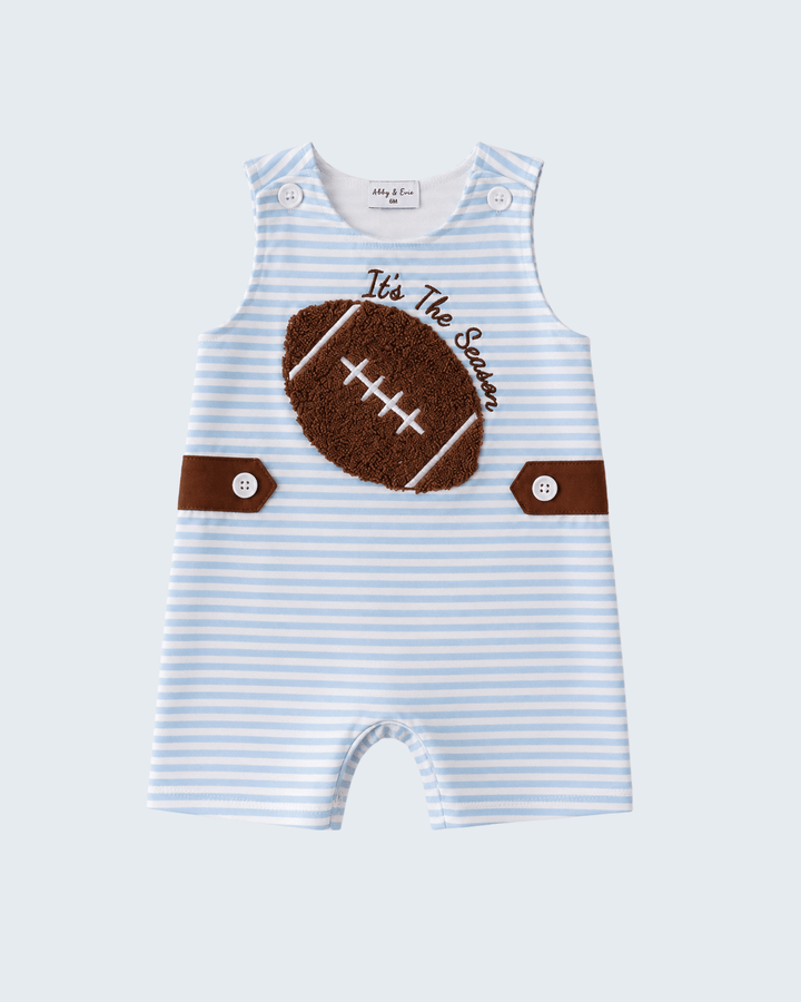 A baby romper in light blue and white stripes, featuring a brown football applique with &