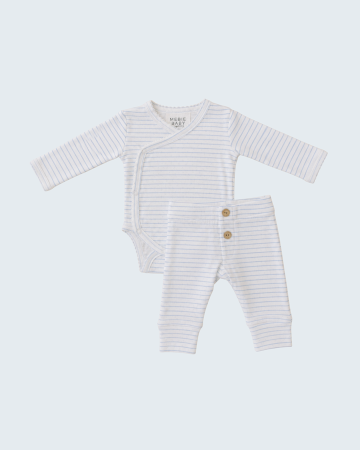 Striped baby romper and pants set on a light gray background
