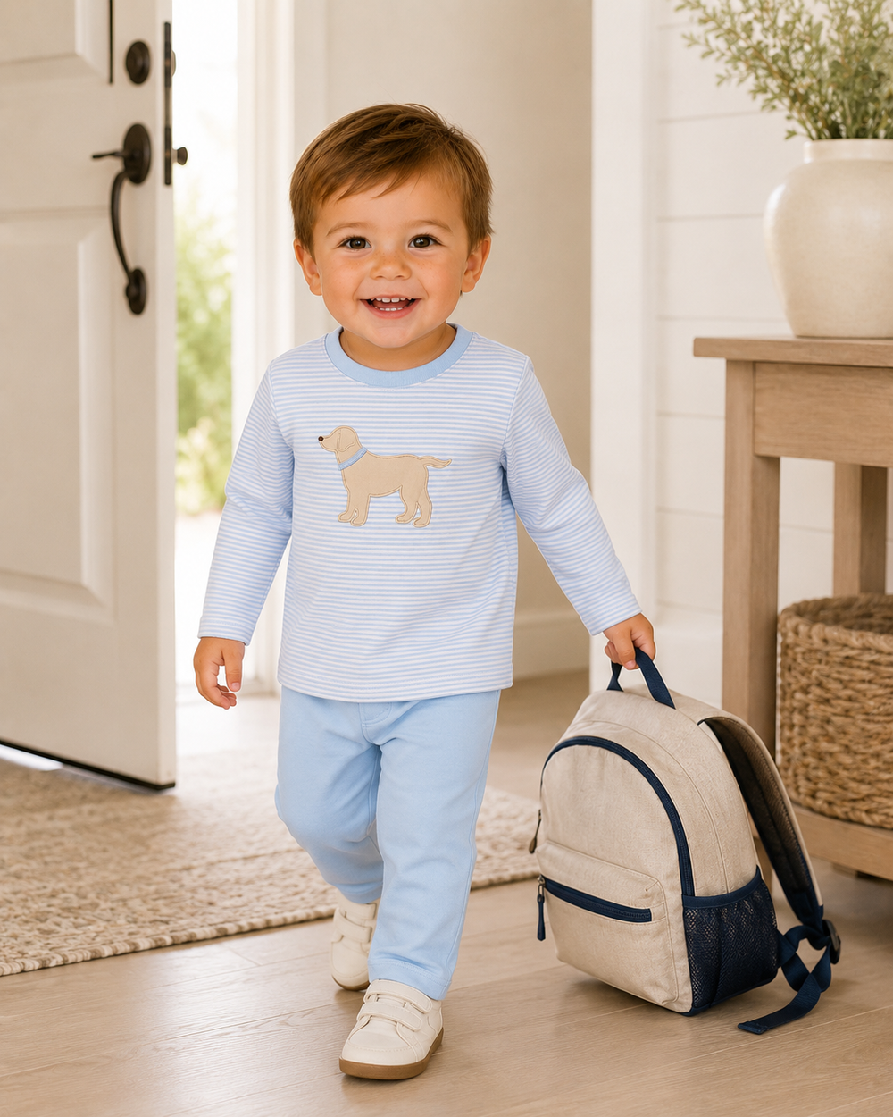 Toddler wearing striped dog applique top with light blue pajama pants