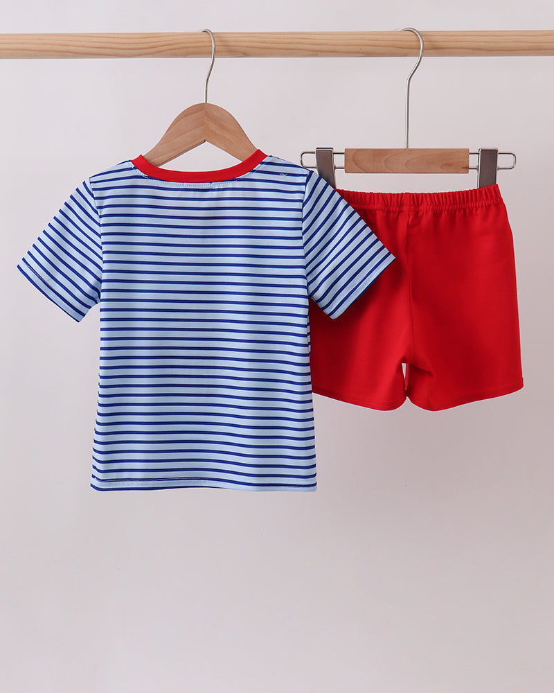 Blue striped T-shirt and red shorts set on hangers