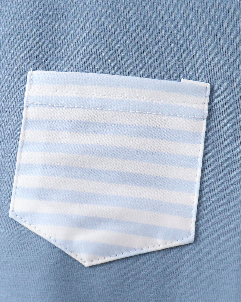 Close-up of a blue shirt with a striped pocket