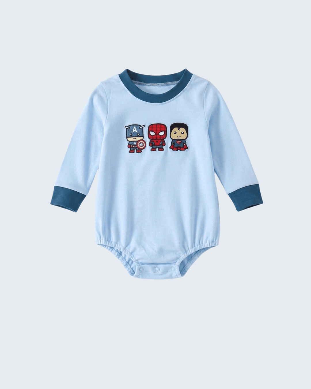 A light blue long-sleeve baby bodysuit with dark blue ribbed collar and cuffs, featuring three cartoon superhero characters printed on the chest.