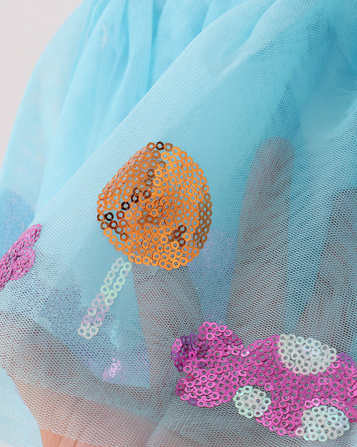Close-up of blue tulle tutu skirt with orange, purple, and silver heart sequin appliques