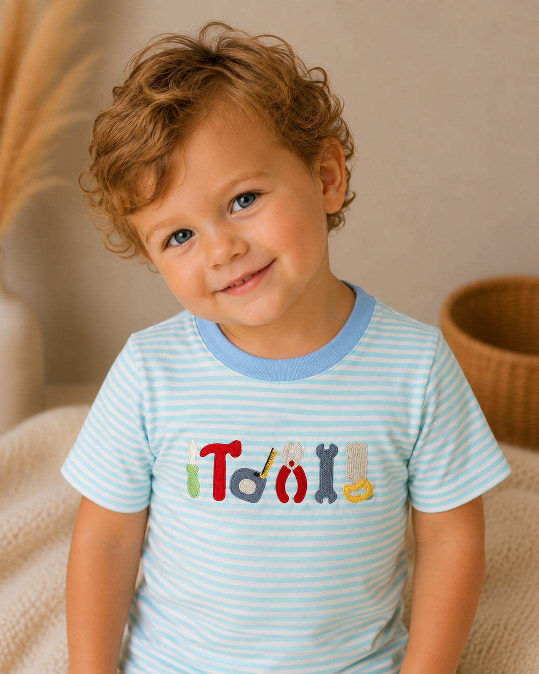 Light blue striped crew-neck T-shirt with colorful tool embroidery front