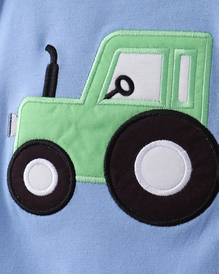 Green tractor applique on a blue background