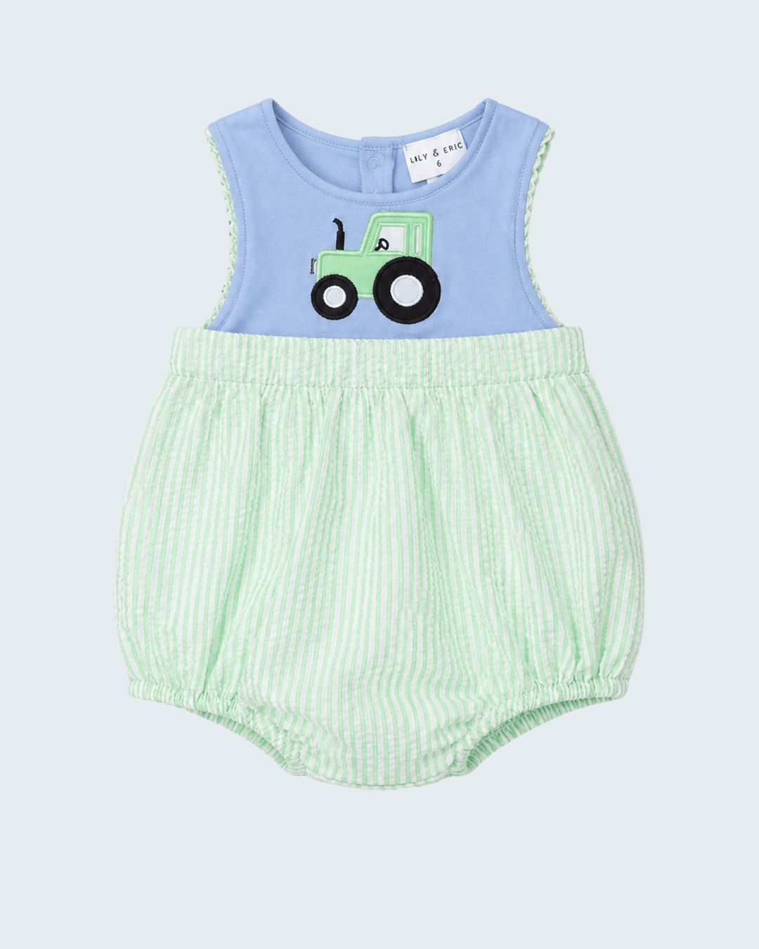 Baby romper with blue top and green striped bottom on a light gray background