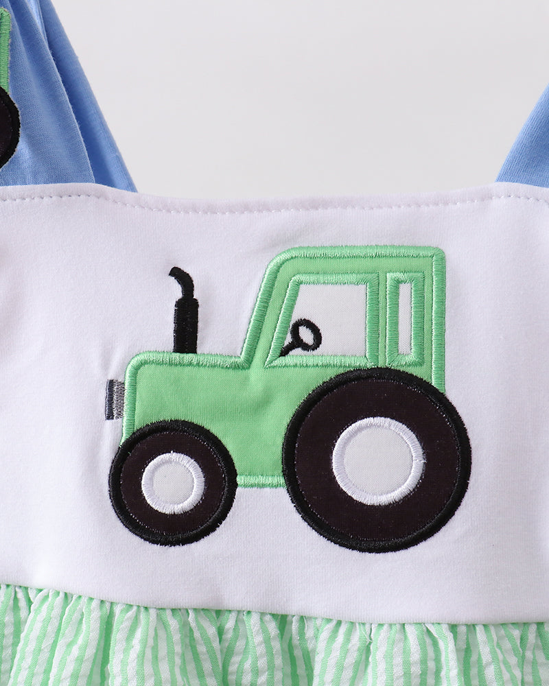 Green and white dress with a green tractor design on a white background