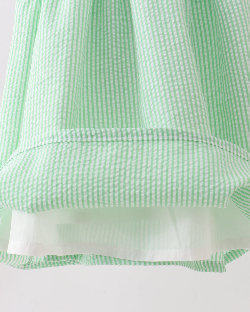 Close-up of a green and white checkered fabric with a white background