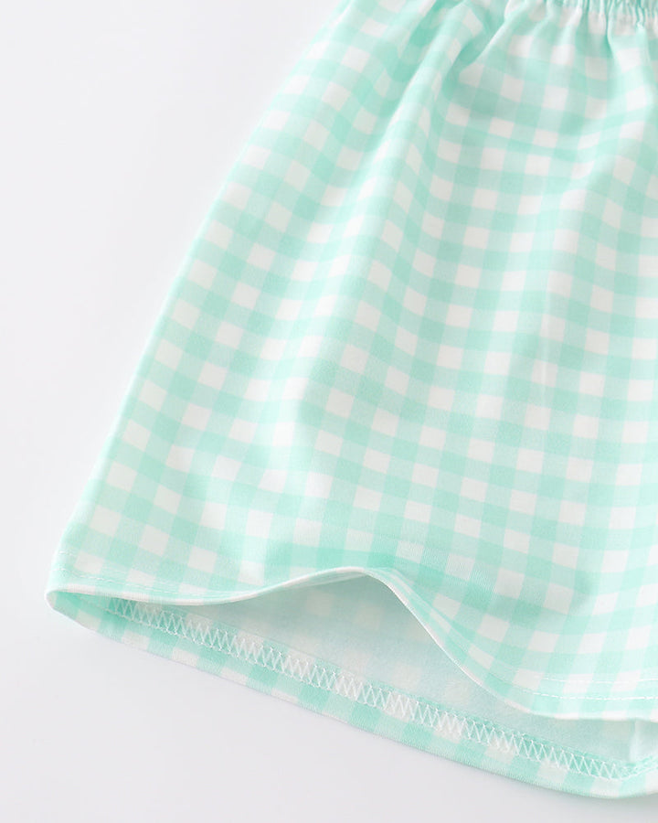 Green checkered fabric on a white background