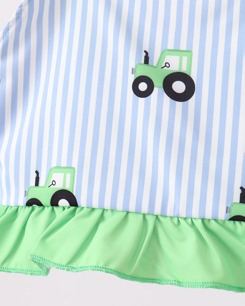 Striped fabric with green tractors and a green border on a white background