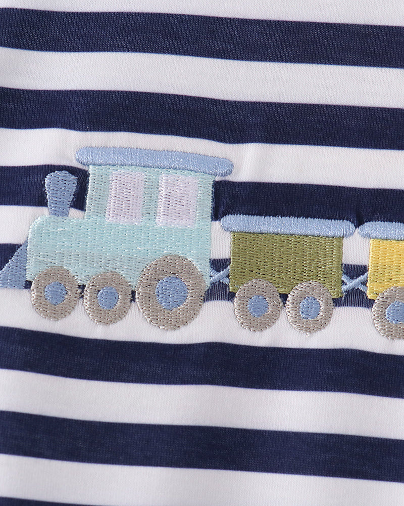 Train motif applique with blue, yellow, and gray cars on striped fabric