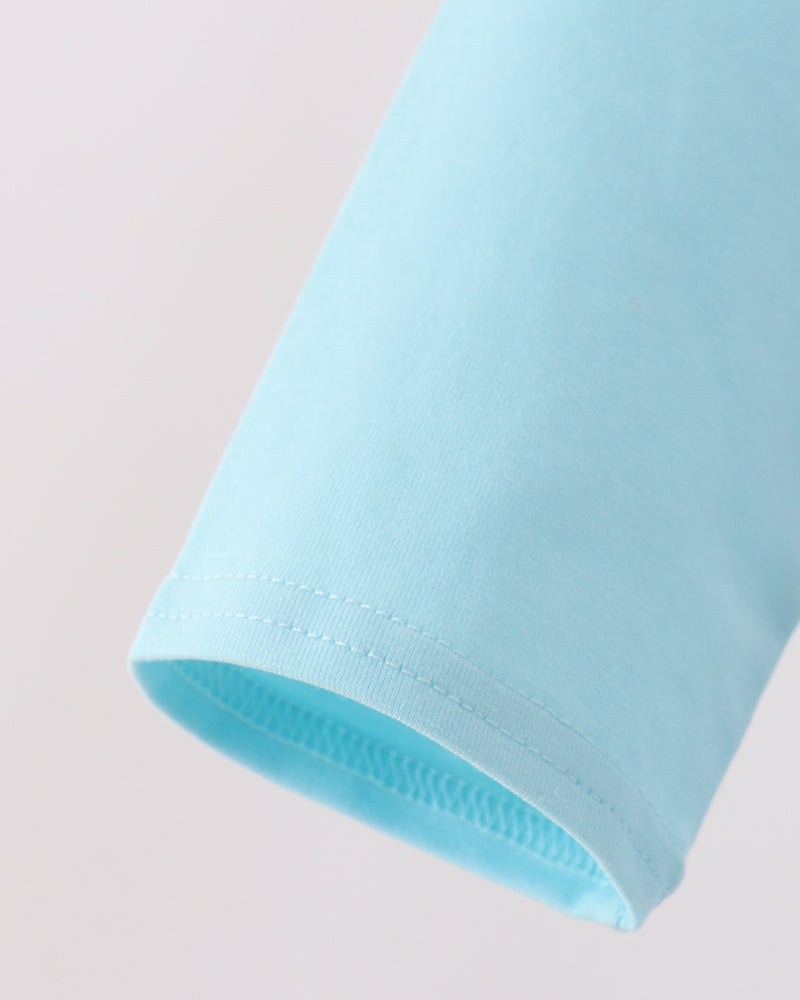 Light blue raglan sleeve with stitched hem and visible seam stitching