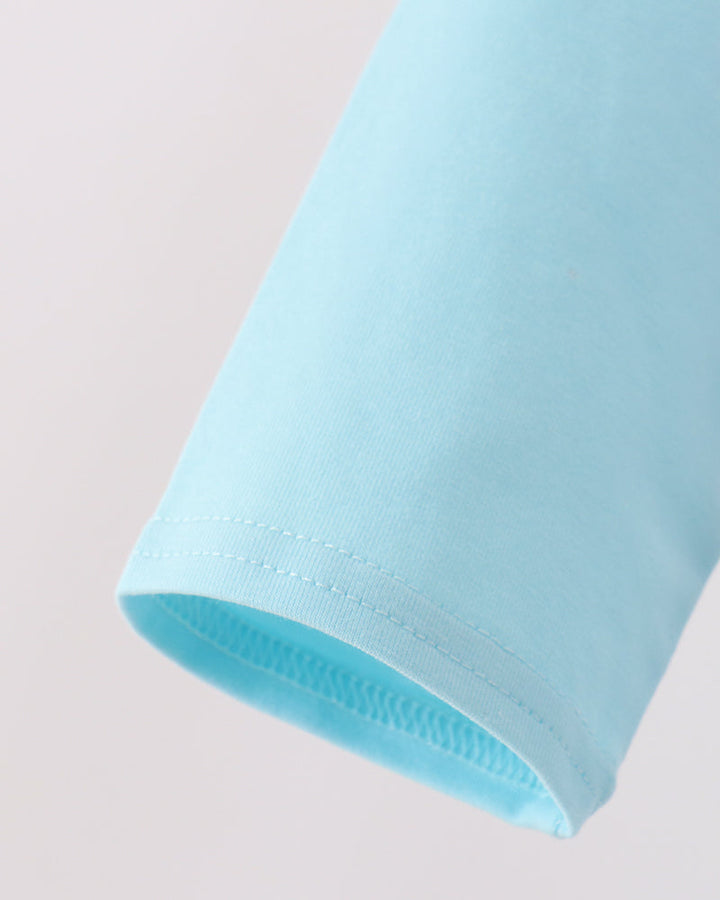 Light blue raglan sleeve with stitched hem and visible seam stitching