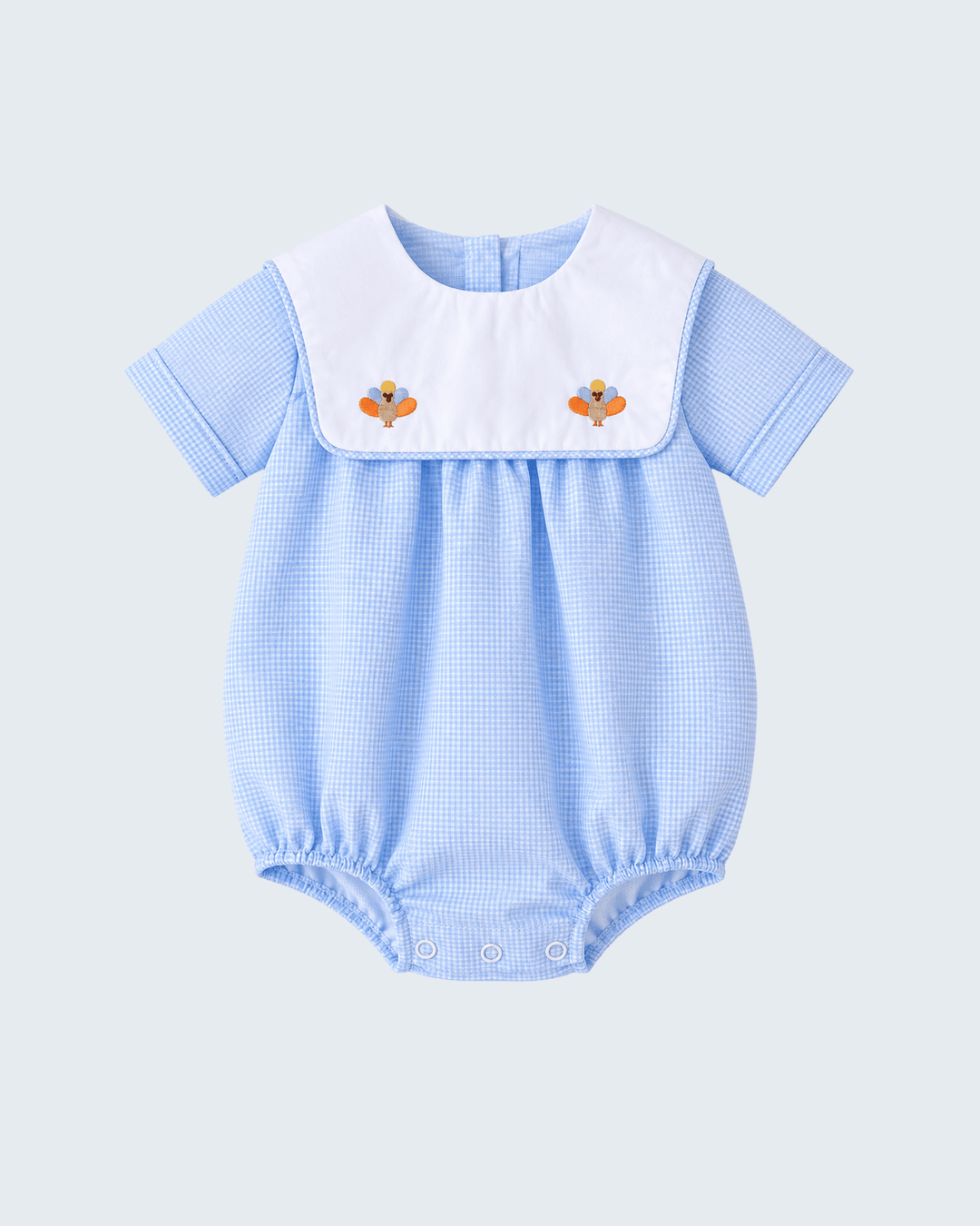 Blue checkered bubble romper with white yoke and two turkey appliques