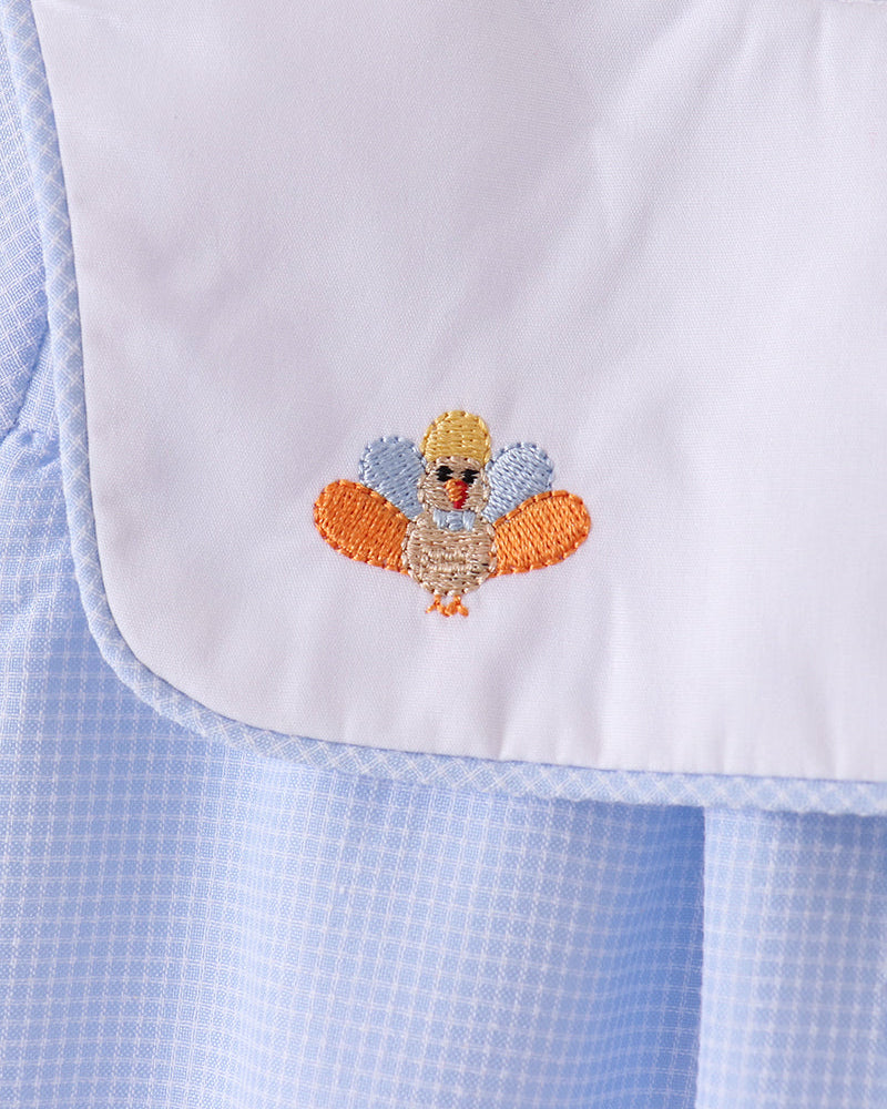 Turkey embroidery on white yoke with orange and blue stitched details