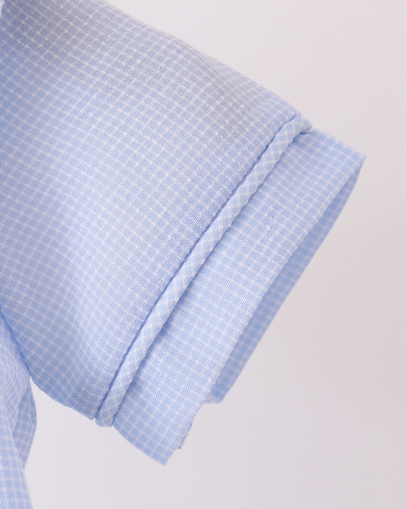 Light blue checkered sleeve cuff with stitched hem and elastic finish