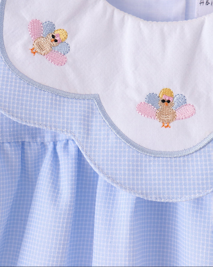 Light blue checkered dress with embroidered turkey patches on front yoke