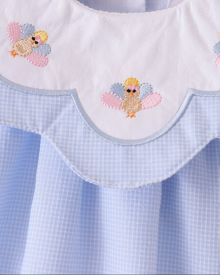Light blue romper neckline bib with ruffled edge and colorful turkey embroidery