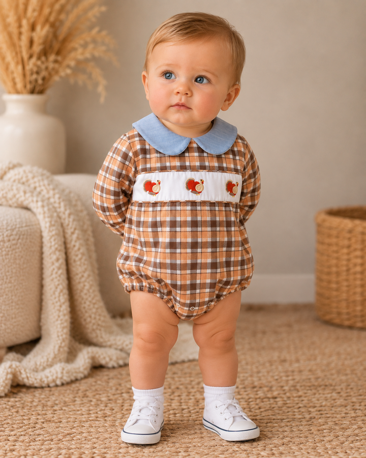 Baby bubble romper in plaid with blue collar and turkey embroidery, worn by toddler