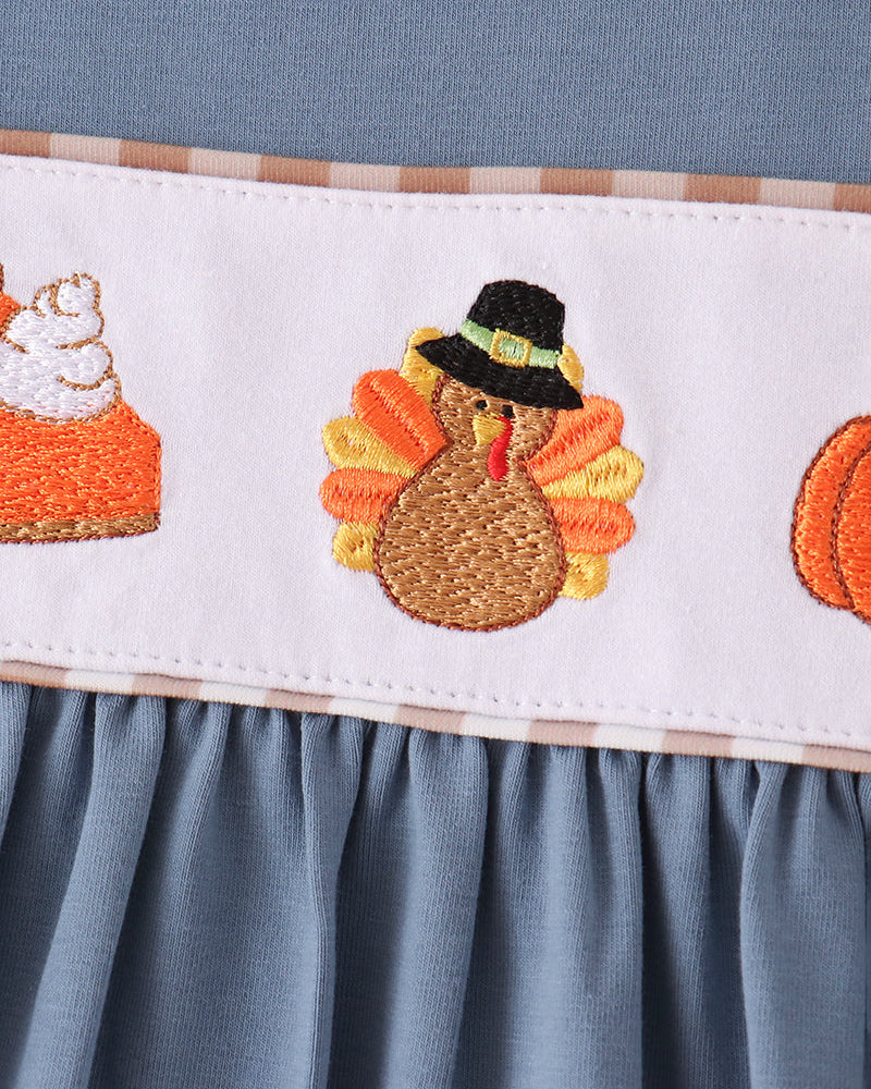 Blue dress yoke with embroidered turkey, pumpkin and orange candy-corn motifs