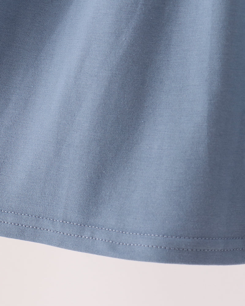 Blue gathered skirt hem with double-stitched seam detail