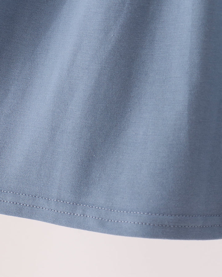 Blue gathered skirt hem with double-stitched seam detail