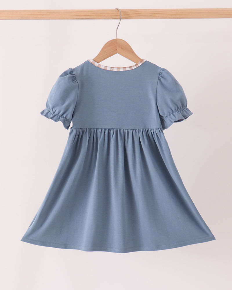 Blue short-sleeve gathered dress with white contrast neck trim, back view