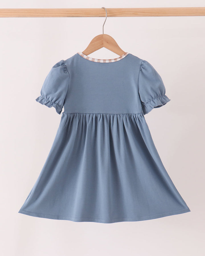 Blue short-sleeve gathered dress with white contrast neck trim, back view